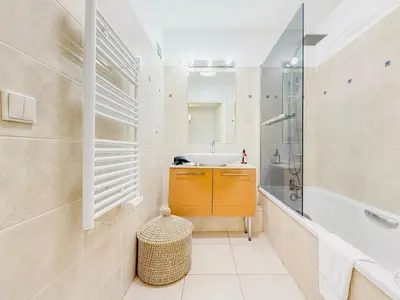 a white bathroom with a sink and a tub and a sink at Terranova Cannes Terrace Accommodation in Cannes
