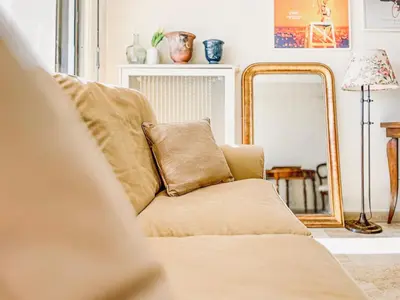 a couch in a living room with a mirror at Cannes Montfleury - Comfortable accommodation Center in Cannes