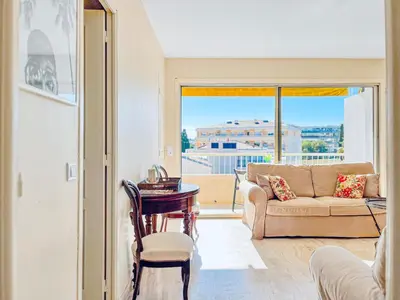 a living room with a couch and a table at Cannes Montfleury - Comfortable accommodation Center in Cannes