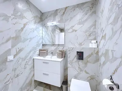 a white bathroom with a sink and a mirror at Le Gatsby - 2 pers - 10 min Palais - AC in Cannes