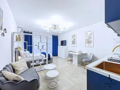 a living room with a couch and a kitchen at Le Gatsby - 2 pers - 10 min Palais - AC in Cannes