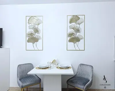 a dining room with a white table and two chairs at Le Gatsby - 2 pers - 10 min Palais - AC in Cannes