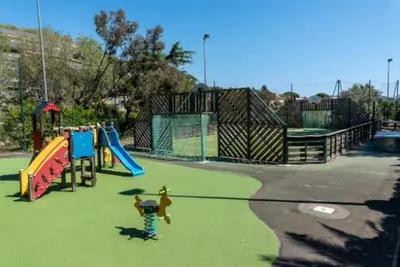 a park with a playground with a slide at Cannes superbe appt 3 pces Wi-Fi Clim Piscine Vue sur les îles et les Paquebots in Cannes