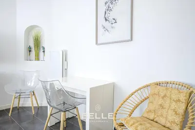 a dining room with a white table and chairs at Le Mimosa in Cannes