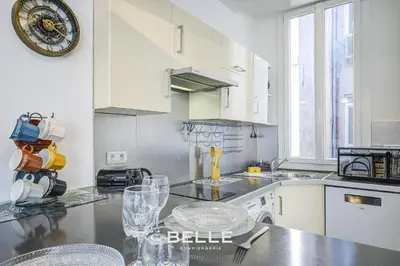 a kitchen with white cabinets and a counter top at Le Mimosa in Cannes