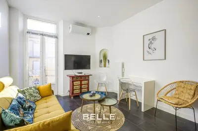 a living room with a couch and a table at Le Mimosa in Cannes
