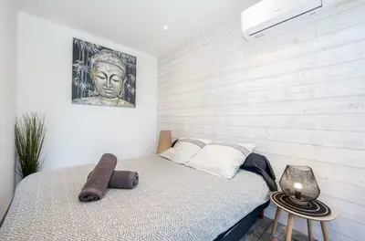 a bedroom with a bed and a painting on the wall at Studio tout confort proche Mer et Croisette in Cannes
