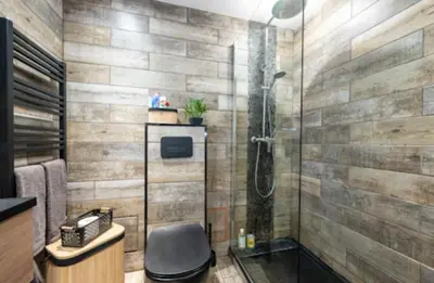 a bathroom with a shower with a chair in it at Studio tout confort proche Mer et Croisette in Cannes