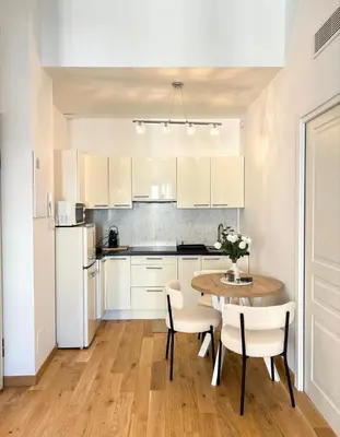 a kitchen with a table with a vase of flowers on it at Casa Dolce Cannes in Cannes