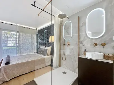 a kitchen with white cabinets and a white refrigerator at StudioLuxCannes - Suite premium avec baignoire à Cannes, plage à 2 min et Palais des Festivals in Cannes