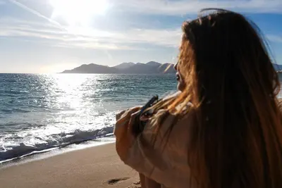 a person holding a wine glass next to a candle at StudioLuxCannes - Suite premium avec baignoire à Cannes, plage à 2 min et Palais des Festivals in Cannes