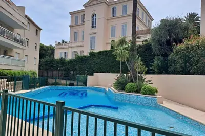 a swimming pool in front of a building at HENRI CAMILLE RE - Passy1 -Beautiful one bedroom swimming pool and parking in Cannes