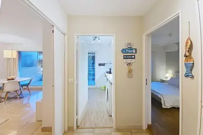 a hallway with a room with a bed and a table at HENRI CAMILLE RE - Passy1 -Beautiful one bedroom swimming pool and parking in Cannes