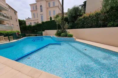 a swimming pool in front of a building at HENRI CAMILLE RE - Passy1 -Beautiful one bedroom swimming pool and parking in Cannes