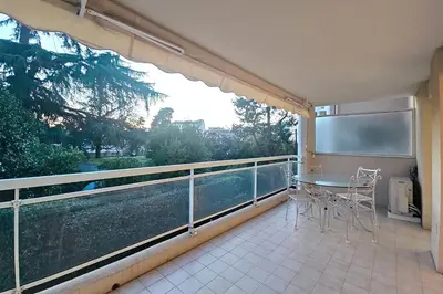 a balcony with a table and chairs on a balcony at HENRI CAMILLE RE - Passy1 -Beautiful one bedroom swimming pool and parking in Cannes