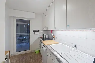 a white kitchen with a sink and a window at HENRI CAMILLE RE - Passy1 -Beautiful one bedroom swimming pool and parking in Cannes