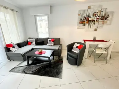 a living room with a couch and a table at Cannes Maria in Cannes