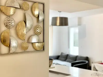 a living room with gold plates on the wall at Cannes Maria in Cannes