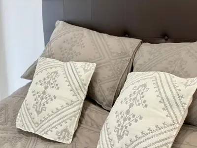 a group of pillows sitting on top of a bed at Cannes Maria in Cannes