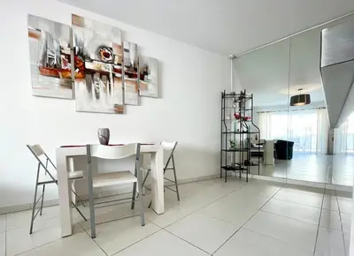 a dining room with a white table and chairs at Cannes Maria in Cannes