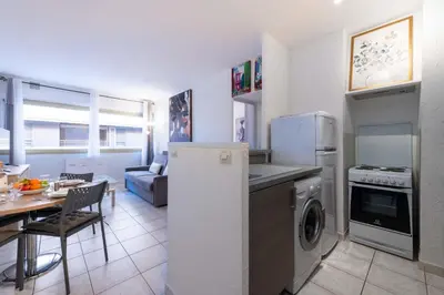 a kitchen and living room with a stove and refrigerator at 1-Br Apartment Palm Beach Near Beaches & La Croisette in Cannes