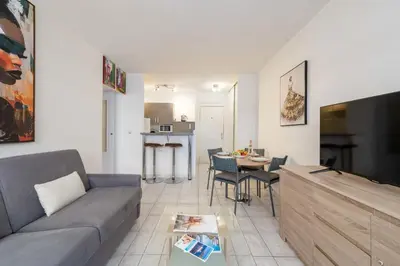 a living room with a couch and a table at 1-Br Apartment Palm Beach Near Beaches & La Croisette in Cannes
