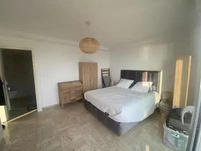 a bedroom with a bed and a television in it at Primavera in Cannes