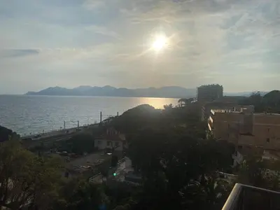 a view of the ocean with the sun in the sky at Primavera in Cannes