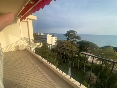 a balcony of a building with a view of the ocean at Primavera in Cannes