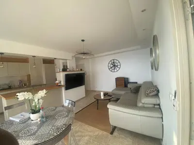 a living room and kitchen with a couch and a table at Primavera in Cannes