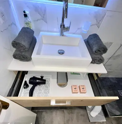 a bathroom with a sink in a display case at Heart of Cannes Azure Home in Cannes