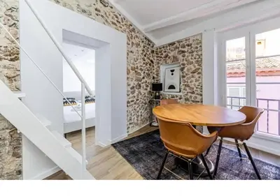 a dining room with a table and two chairs at Bright Apartment Mezzanine in the Heart of Suquet in Cannes
