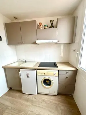 a small kitchen with a washing machine in it at Appartement Rue de la Rampe in Cannes