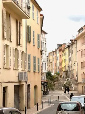 a city street with buildings and cars parked on the street at Appartement Rue de la Rampe in Cannes