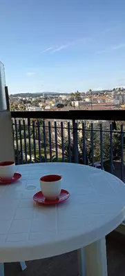 a white table with two cups on a balcony at Studio LE MEDITERRANEE in Cannes