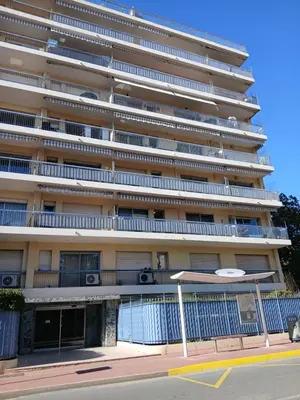 a balcony with a table and a view of a city at Studio LE MEDITERRANEE in Cannes