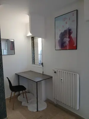 a table and a chair in a room at Studio LE MEDITERRANEE in Cannes