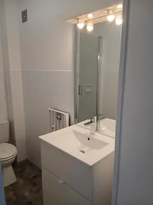 a white bathroom with a sink and a toilet at Studio LE MEDITERRANEE in Cannes