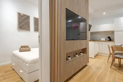 a bedroom with a bed and a mirror on a wall at Élégant 2P Rue Meynadier Proche du Palais et des plages in Cannes