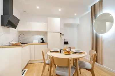 a kitchen with a table and chairs in a room at Élégant 2P Rue Meynadier Proche du Palais et des plages in Cannes