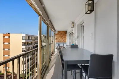 a balcony with a black table and chairs on it at 11 MADRID - Splendid one-bedroom apartment near Croisette in Cannes