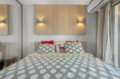 a bedroom with a bed and two pillows on it at 11 MADRID - Splendid one-bedroom apartment near Croisette in Cannes