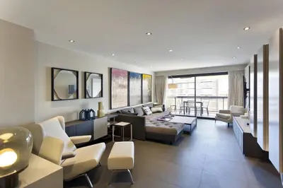 a living room with a couch and a table at 2 chambres au cœur de Cannes - Croisette et plages à 1 min in Cannes