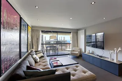 a living room with a couch and a table at 2 chambres au cœur de Cannes - Croisette et plages à 1 min in Cannes