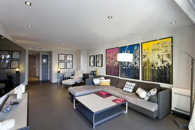 a living room with a couch and a table at 2 chambres au cœur de Cannes - Croisette et plages à 1 min in Cannes