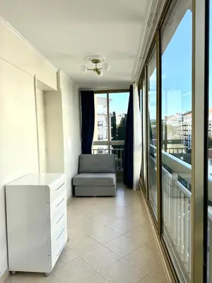 a living room with a couch and a window at Carlton Exclusive - Elégant T2 au coeur de la Croisette in Cannes