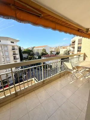 a balcony with chairs and a view of a city at Carlton Exclusive - Elégant T2 au coeur de la Croisette in Cannes