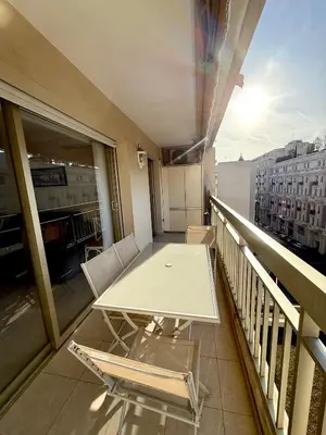 a table and chairs on a balcony with a view at Carlton Exclusive - Elégant T2 au coeur de la Croisette in Cannes