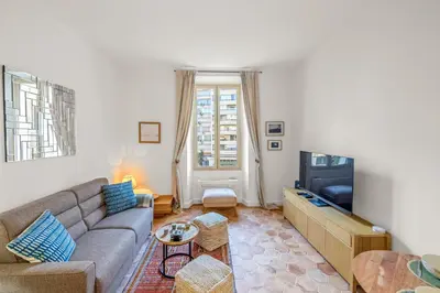 a living room with a couch and a tv at REF 2038 - Cannes - Superb fully renovated one-bedroom apartment in Cannes