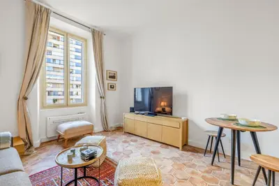 a living room with a tv and a table at REF 2038 - Cannes - Superb fully renovated one-bedroom apartment in Cannes
